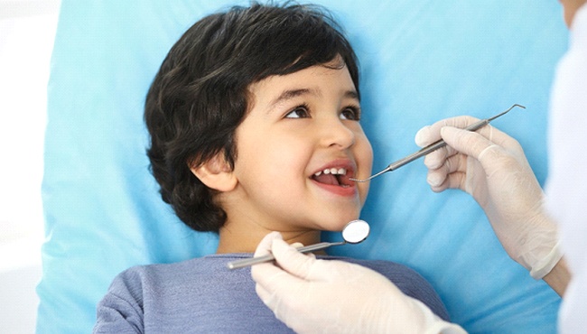 Boy smiles after getting dental sealants in Buffalo Grove