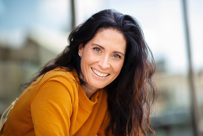 A beautiful middle-aged woman smiling outdoors